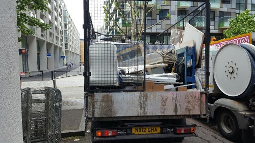 Skip hire company truck delivering a skip to a residential property in Chingford